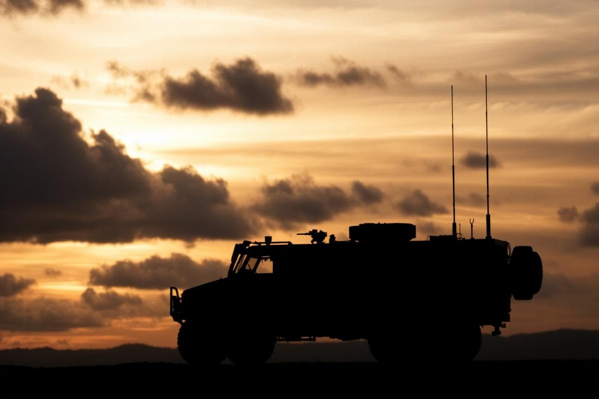 Vehicle silhouette against a sunset sky